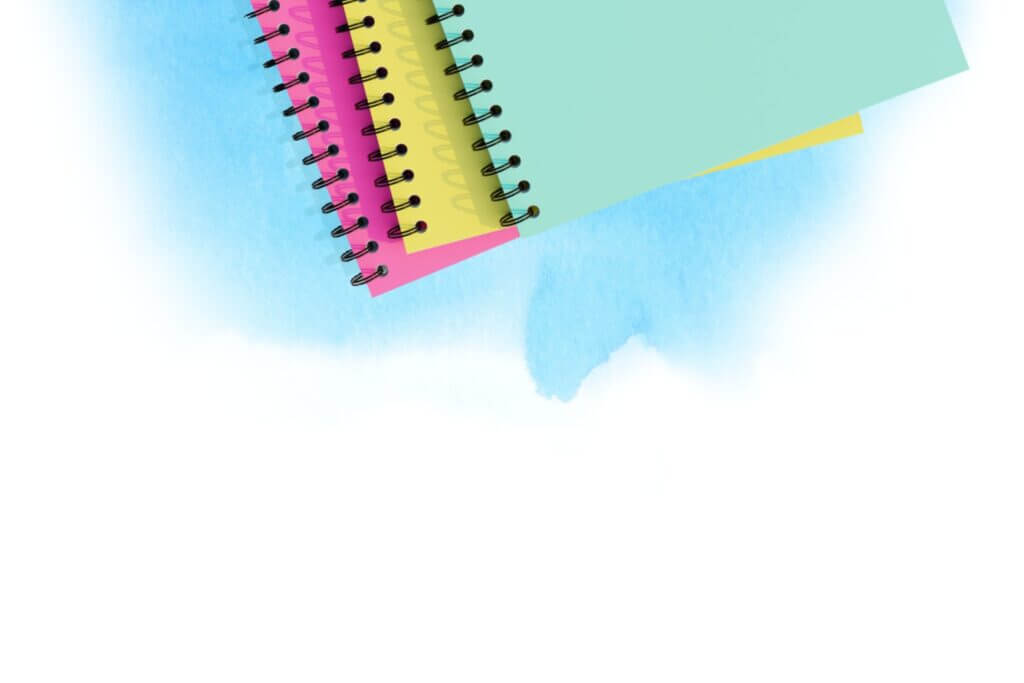 Colorful spiral-bound notebooks laying on a watercolor textured background.